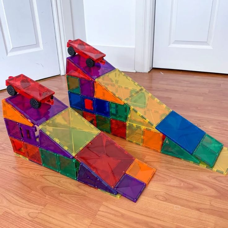 two colorful blocks are stacked on top of each other in front of a white door