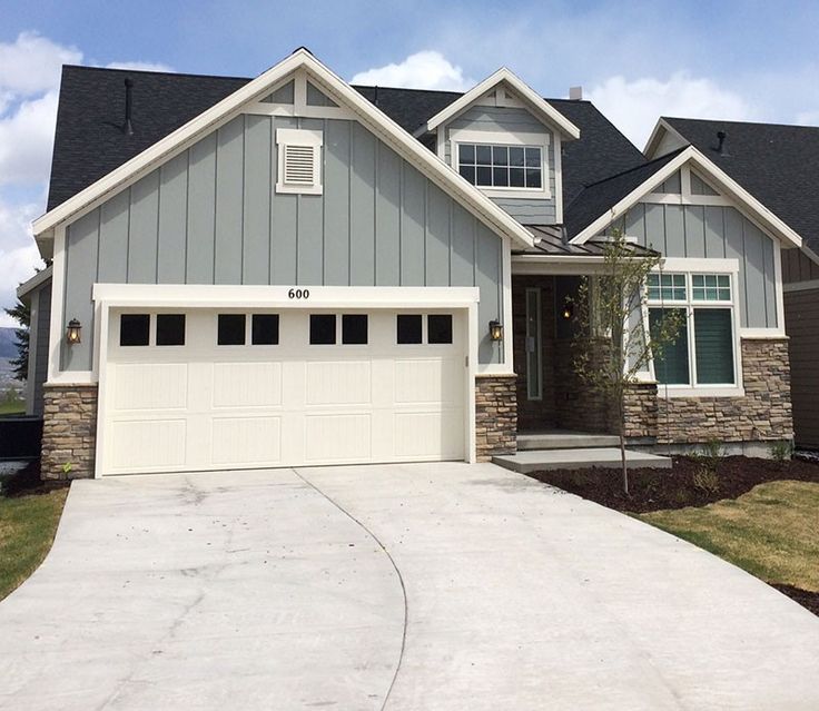 a large house with two garages in the front and one on the other side