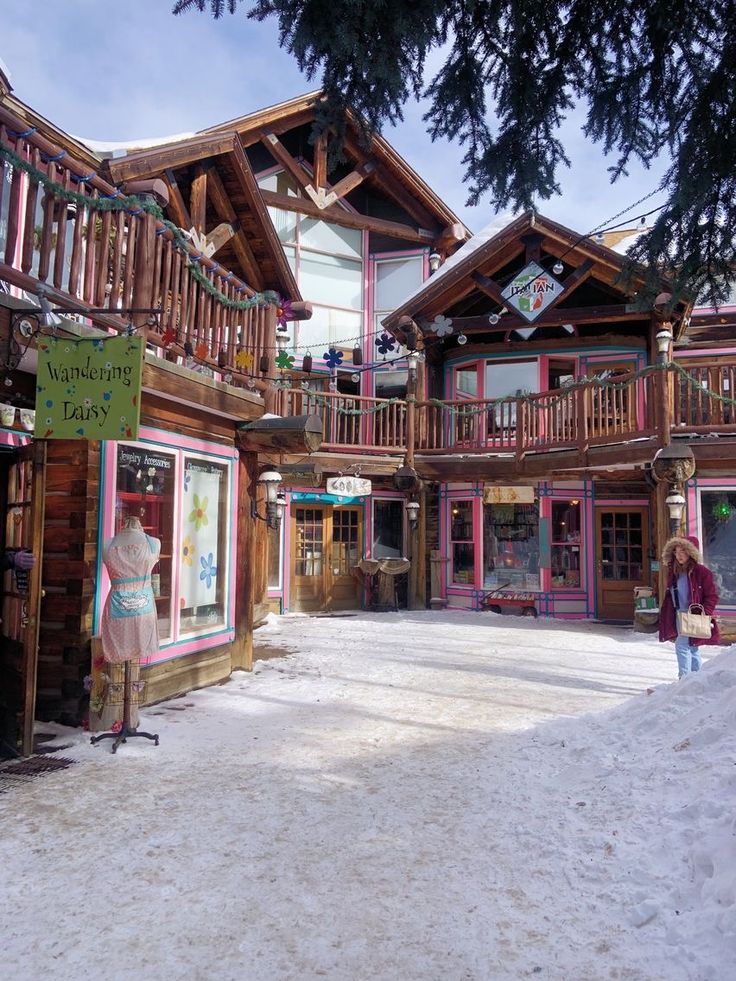 a woman standing in front of a wooden building