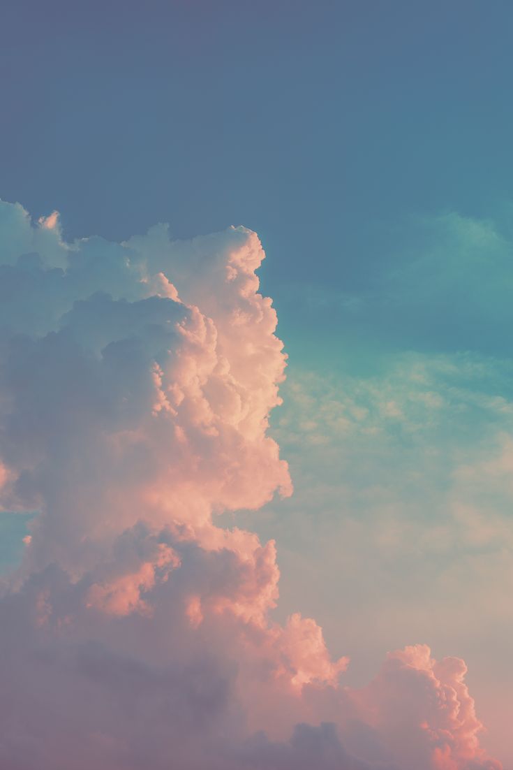 an airplane is flying in the sky with some clouds above it at sunset or dawn