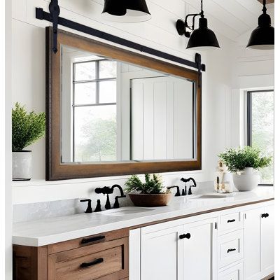 a bathroom with two sinks and a large mirror on the wall above it's counter