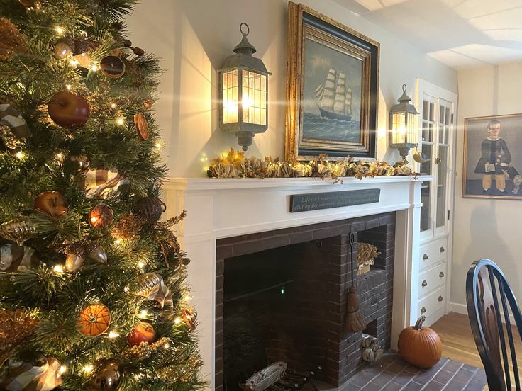 a decorated christmas tree in the corner of a living room next to a fire place