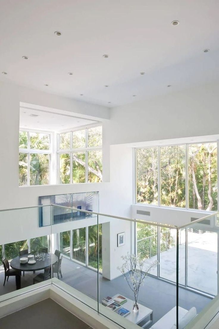 the interior of a modern house with glass railings