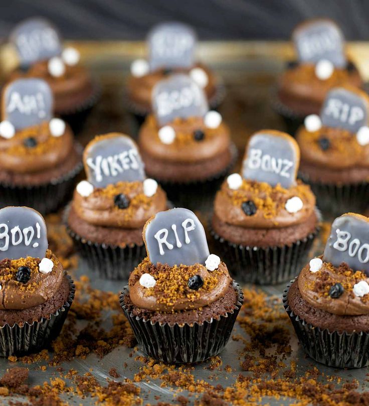 chocolate cupcakes decorated with frosting and tombstones