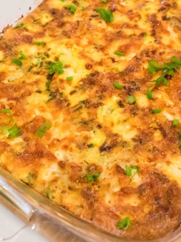 a casserole dish with cheese and herbs