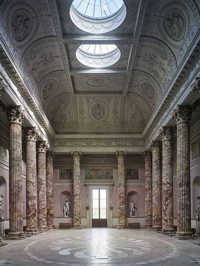 the interior of an old building with marble columns