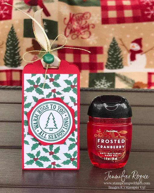 an empty christmas gift tag next to a bottle of holiday cranberry jam on a table