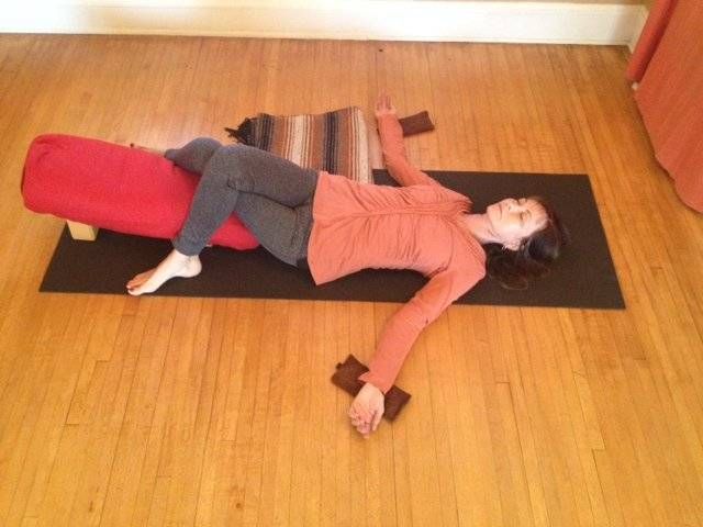 a woman laying on top of a yoga mat