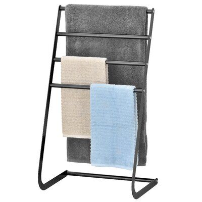 a towel rack with three towels hanging from it's sides and two folded ones on each side