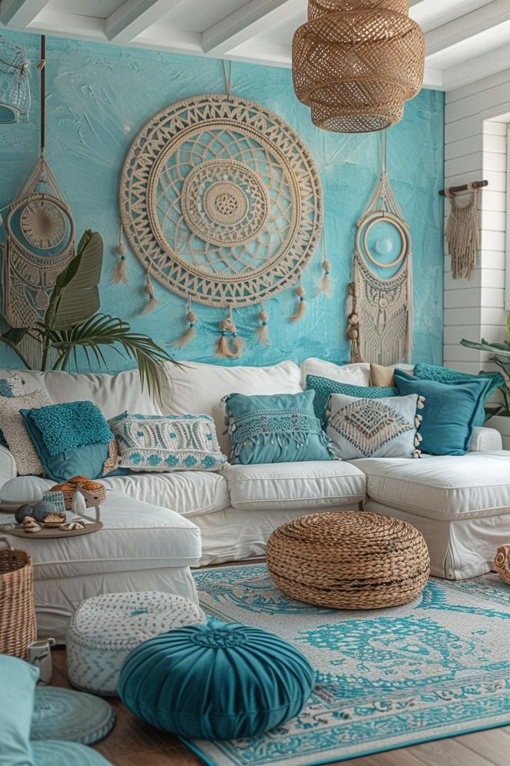 a living room filled with lots of white furniture and blue pillows on top of it