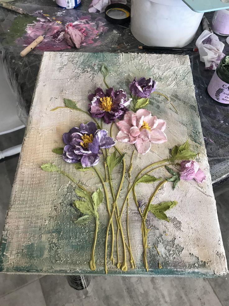 some flowers are sitting on top of a piece of paper and it's been painted