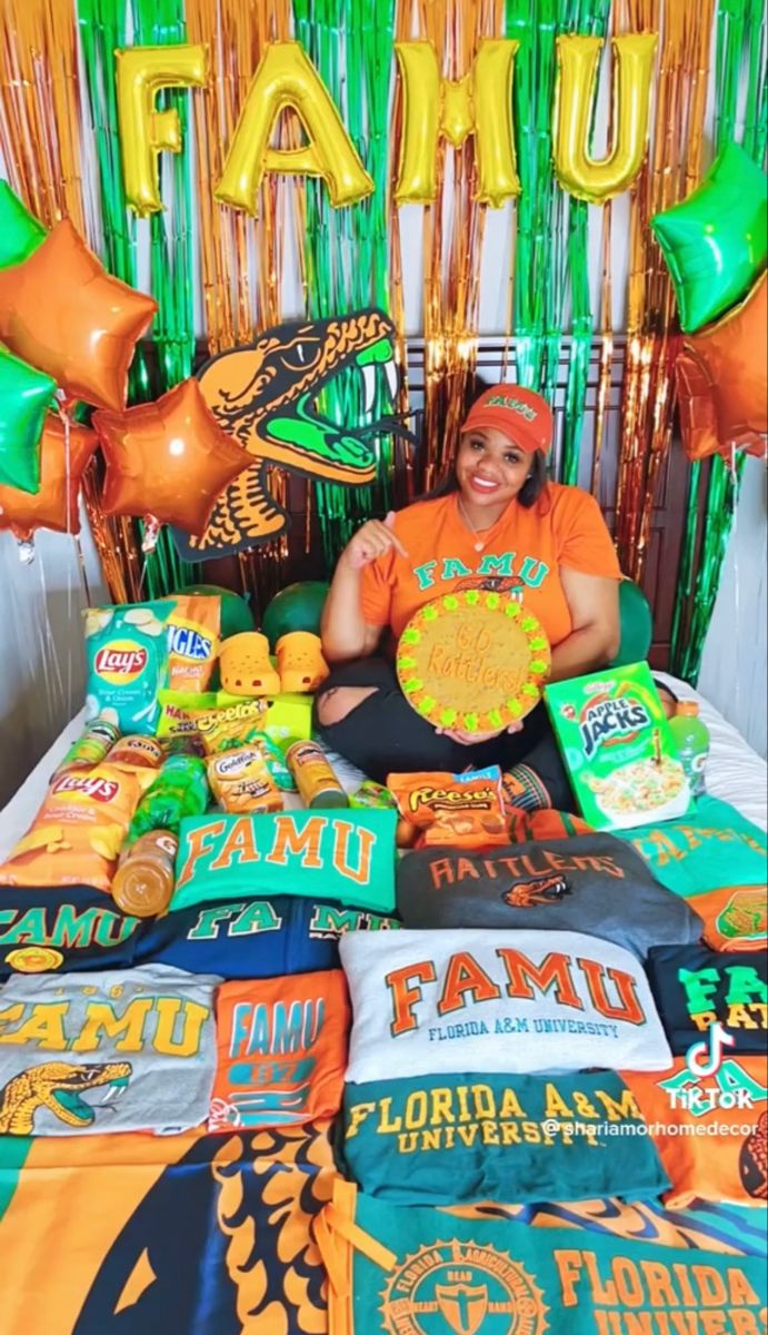 a woman sitting in front of a table full of food and balloons with the word famu on it