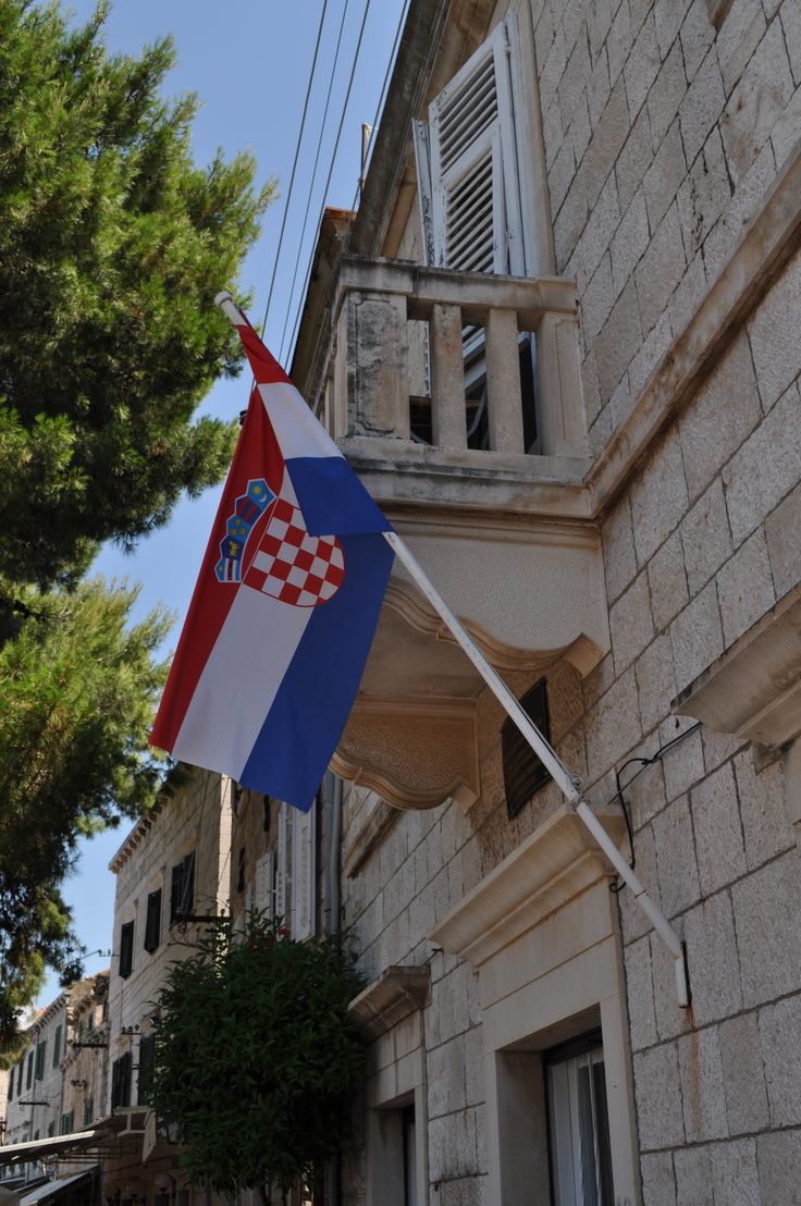 a flag is flying outside an old building