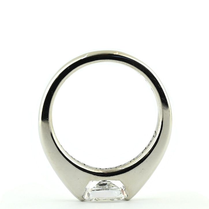 a white gold ring with a diamond on the top and side view, against a white background