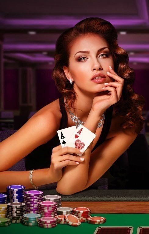 a woman leaning on a table with cards and poker chips in front of her as she looks at the camera