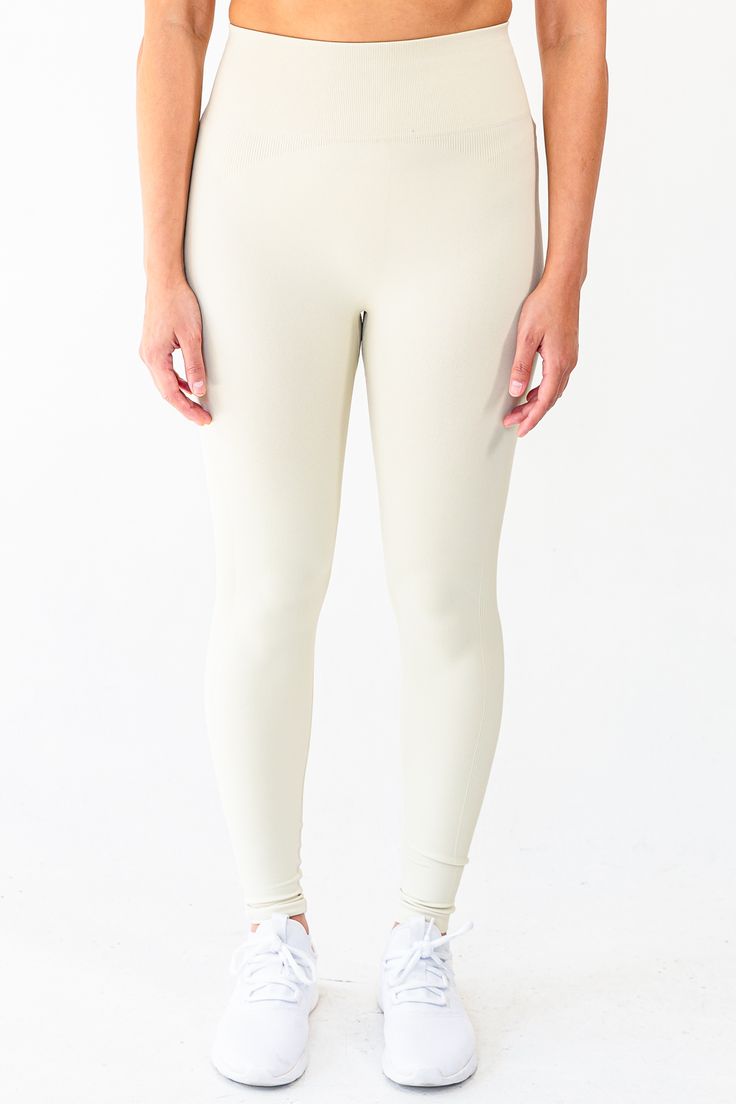 The Contrast Legging in Cream embodies a union of function and aesthetic. Crafted from moisture-wicking, 4-way stretch power fabric, the garment is lightweight, breathable, and functional. The minimal design is discreetly elevated through the inclusion of ribbing detail down the side of the legs as well as around the glutes. Branding details include an inconspicuous SLAIT logo in reflective detail located on the back of the waistband. Material: 87% Nylon & 13% Spandex GSM: 280G Model is 5'8" and wears a size M Solid Leggings With Go-dry For Light Exercise, Full Length 4-way Stretch Activewear For Light Exercise, Fitted Go-dry Yoga Pants For Light Exercise, Fitted Moisture-wicking Tights For Light Exercise, Minimal Stretch Nylon Activewear For Gym, Moisture-wicking Fitted Tights For Light Exercise, Nylon Athleisure Activewear, Versatile Solid Activewear With Minimal Stretch, Solid Elastane Leggings For Light Exercise