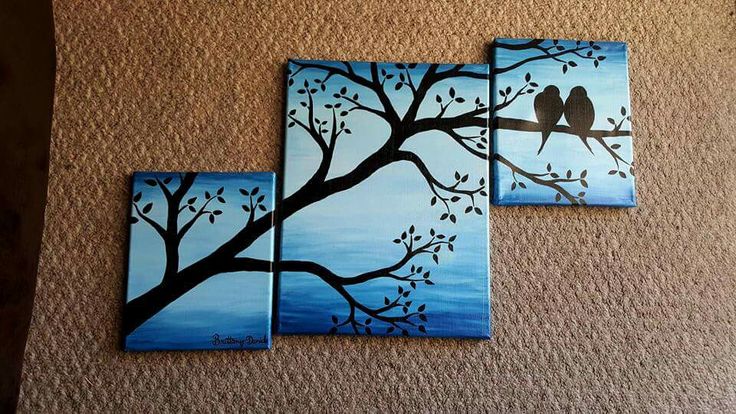 two birds sitting on a tree branch painted on canvases