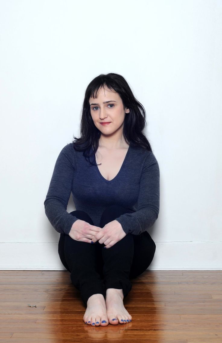 a woman sitting on the floor with her legs crossed