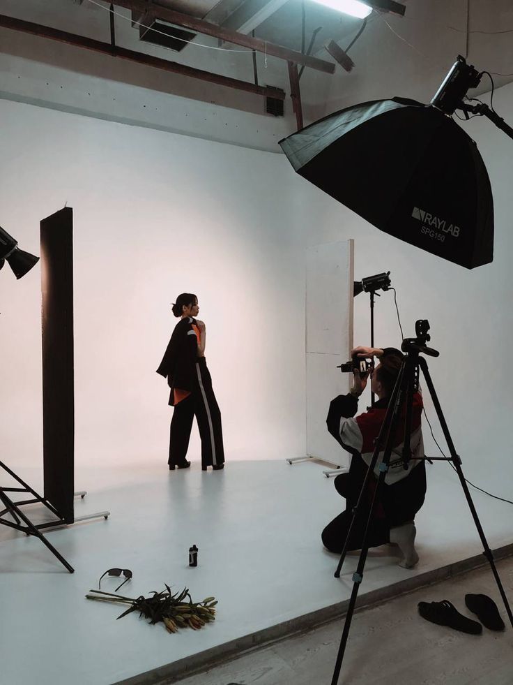 a woman is standing in front of a camera