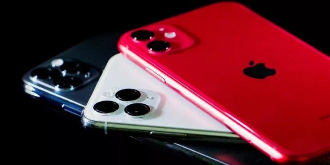 two red and white iphones sitting next to each other on top of a table