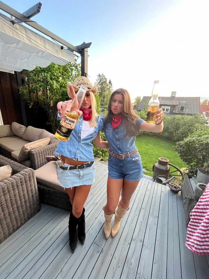 two women are standing on a deck with beer