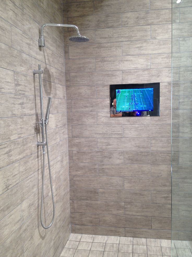 there is a tv in the corner of this shower