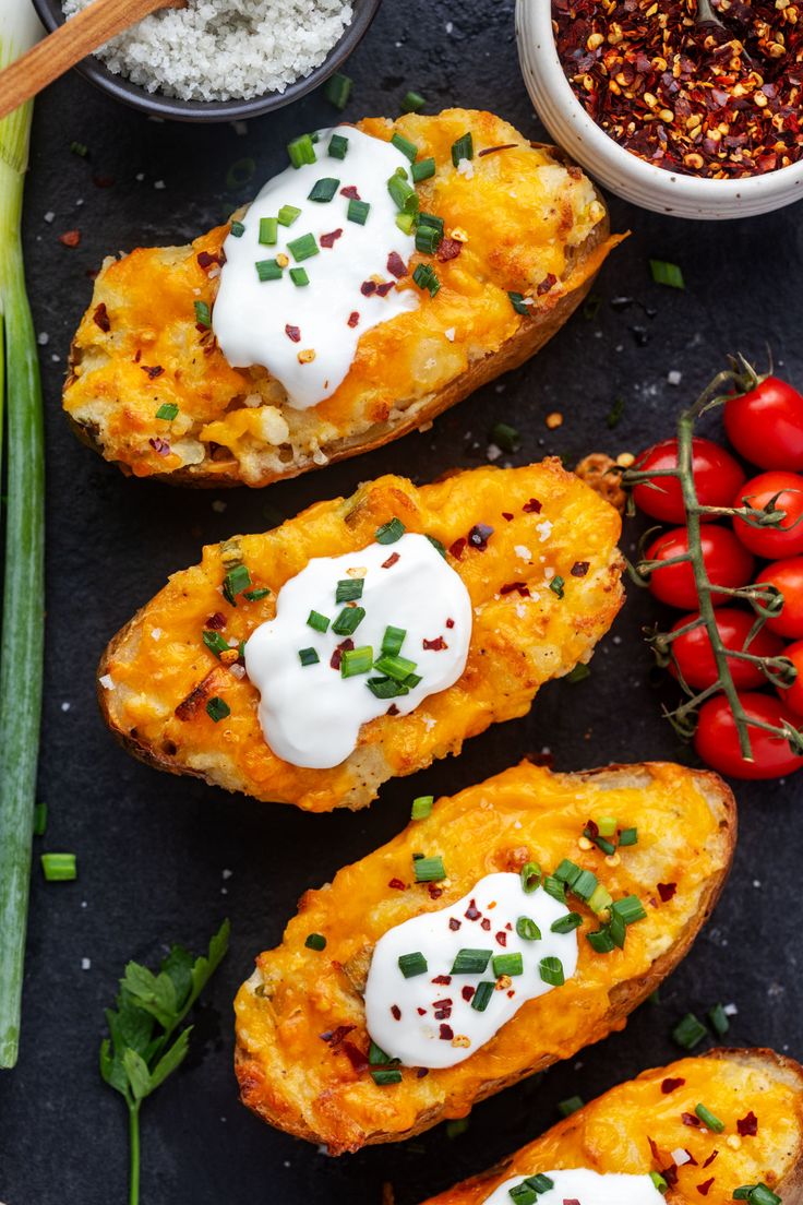 baked potato skins with sour cream and chives on top, surrounded by other ingredients