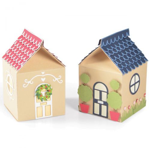 two small cardboard houses sitting next to each other