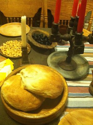 the table is set with bread and other food items for dinner or as an appetizer