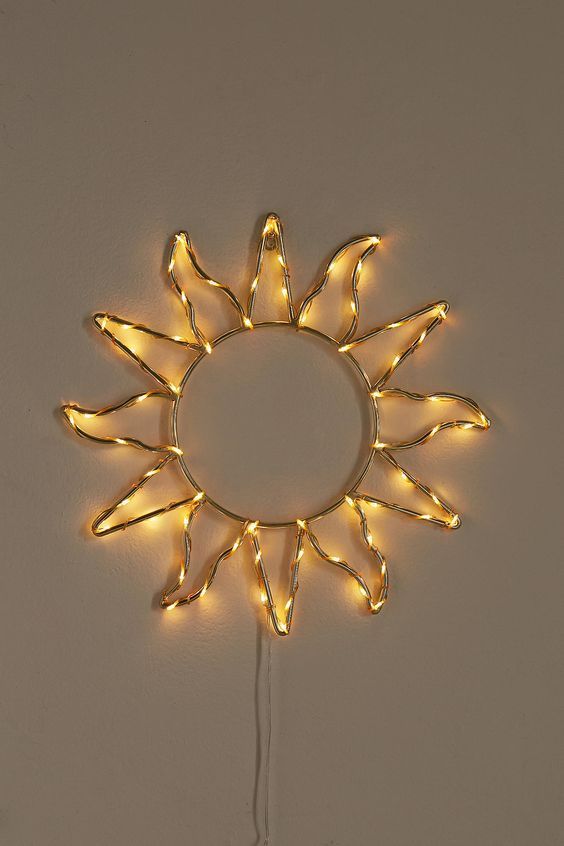 a light up sunburst is hanging on the wall