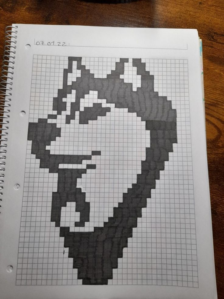 an image of a man's face made out of graph paper on a table