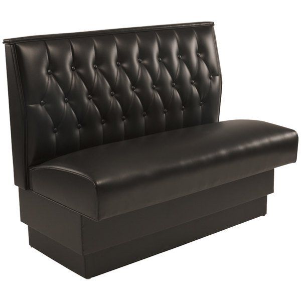 a black leather couch sitting on top of a wooden table