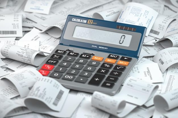 a calculator sitting on top of a pile of paper