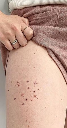 a woman's thigh with small stars on it