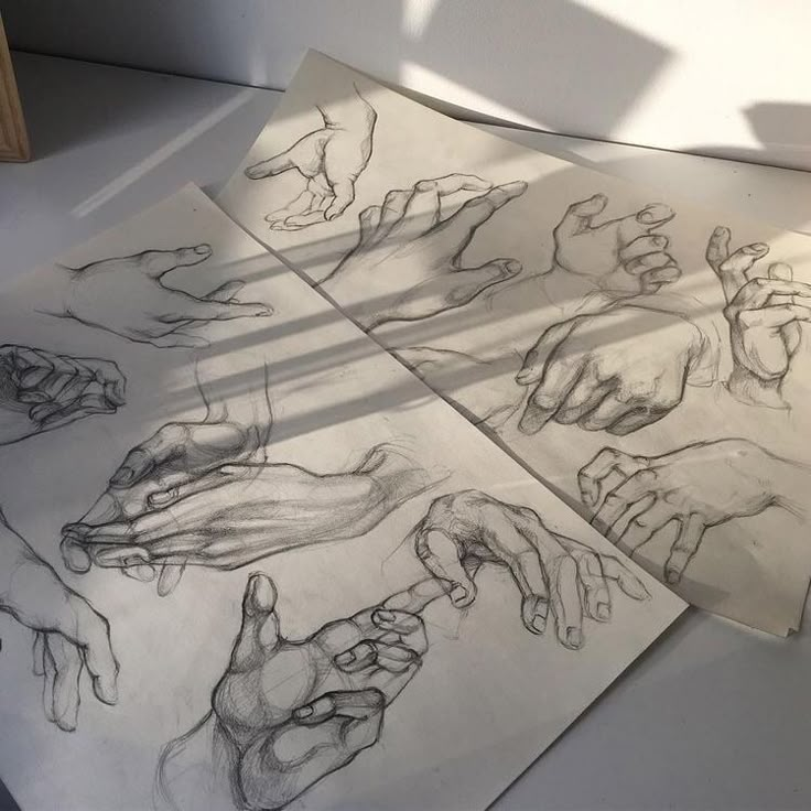 four drawings of hands are shown on the floor