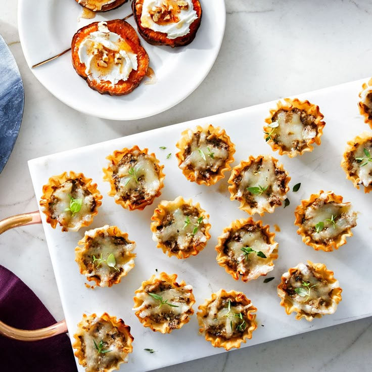 small appetizers are arranged on a platter next to some other food items