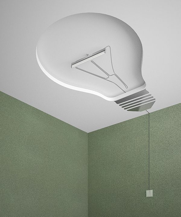 a white light bulb suspended from the ceiling in a room with green walls and flooring