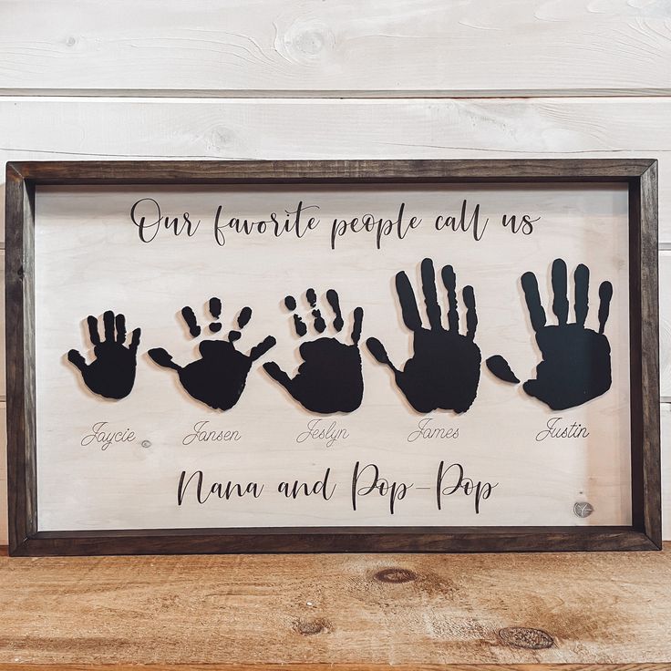 a wooden frame with handprints on it that says our favorite people call us