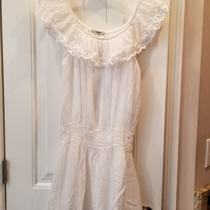 a white dress hanging on a door