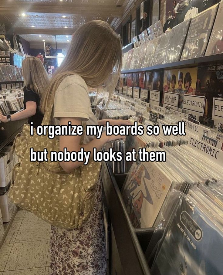 a woman looking at records in a record store with the caption i organize my boards so well, but nobody looks at them