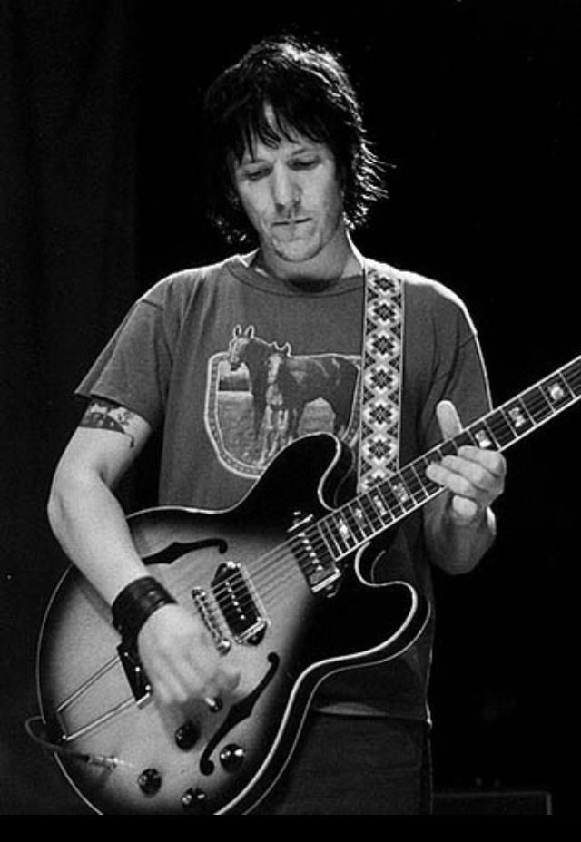 a man playing an electric guitar on stage