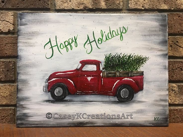 an old red truck with a christmas tree in the back is on display against a brick wall