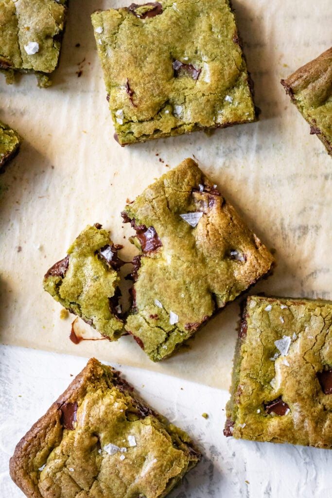 several pieces of chocolate chip cookie bars on a table