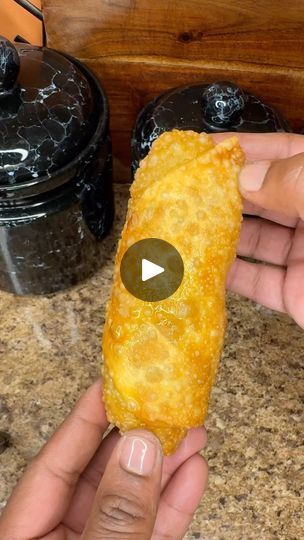 a person holding up a piece of food in their hand with the video below it