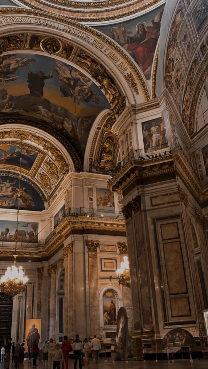 people are standing in an ornately decorated building