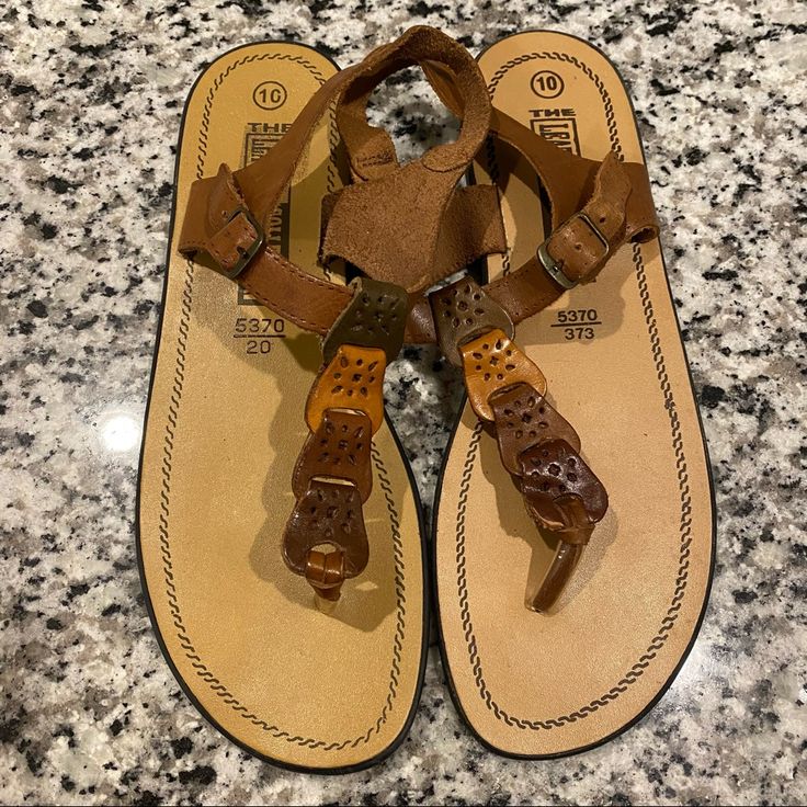 100% Leather Sandals Summer Sandals Brand New Size 10 Brown Open Toe T-strap Sandals For Beach, Brown Toe Post T-strap Sandals For Vacation, Brown Single Toe Strap Flip Flops For Vacation, Brown T-strap Sandals With Single Toe Strap For Vacation, Brown T-strap Sandals With Single Toe Strap For Summer, Brown Leather Footbed T-strap Sandals For Summer, Brown T-strap Sandals For Summer, Summer Brown T-strap Sandals With Single Toe Strap, Casual Brown T-strap Ankle Sandals