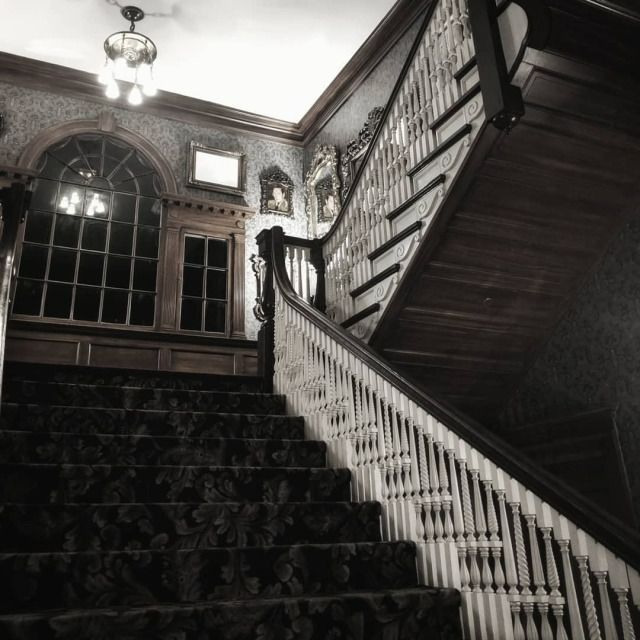 an old fashioned staircase with wrought iron railings