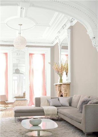 an elegant living room with white walls and carpeted flooring is pictured in this image