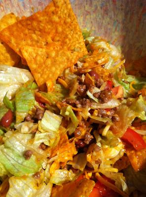 a bowl filled with salad and tortilla chips