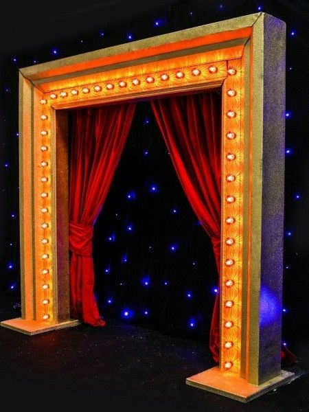 a stage set up with red curtains and lights